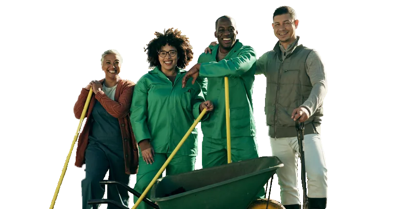 South African farming team smiling with wheelbarrow and tools